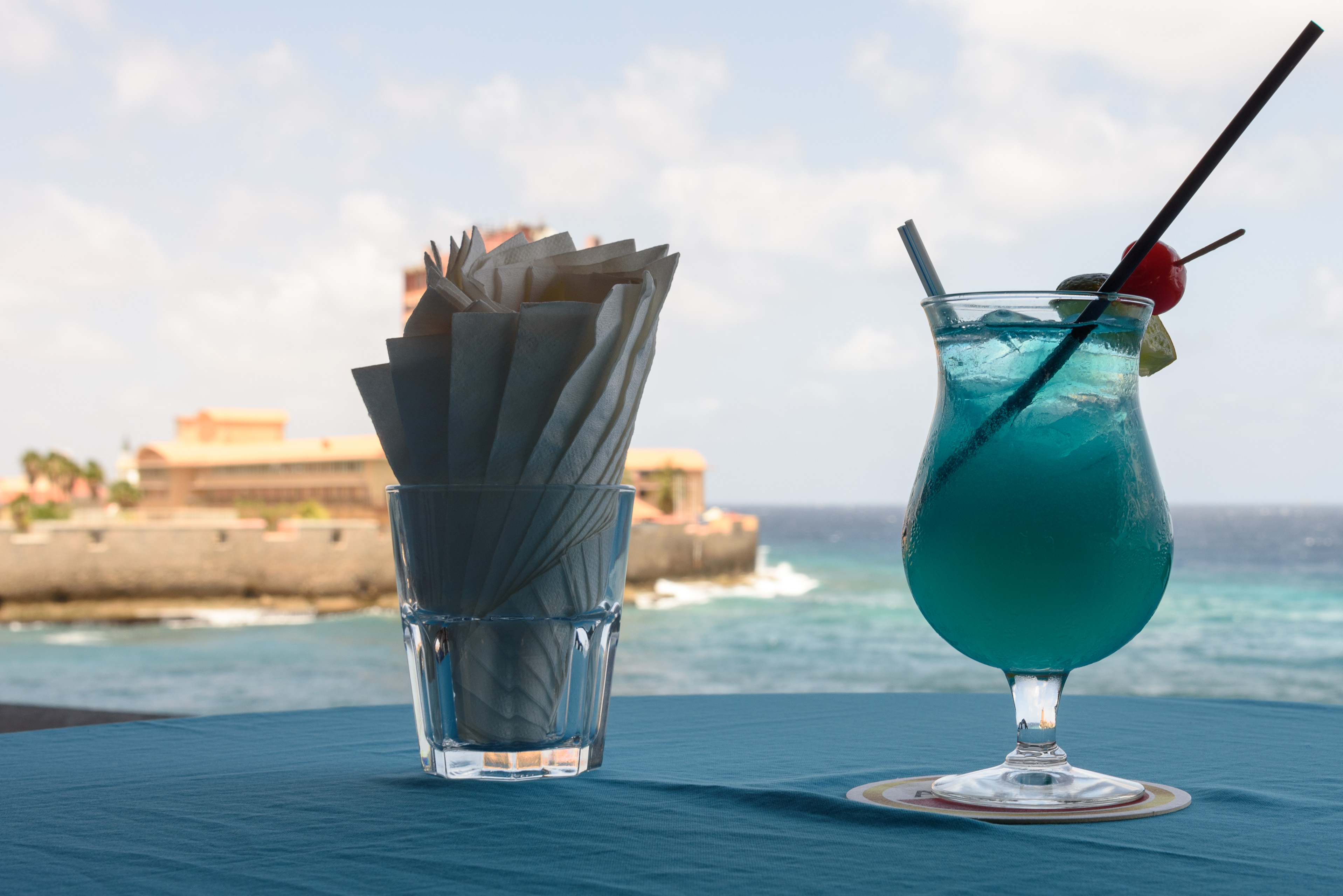 Tasting and enjoying a cocktail with a seaside view in Curacao.